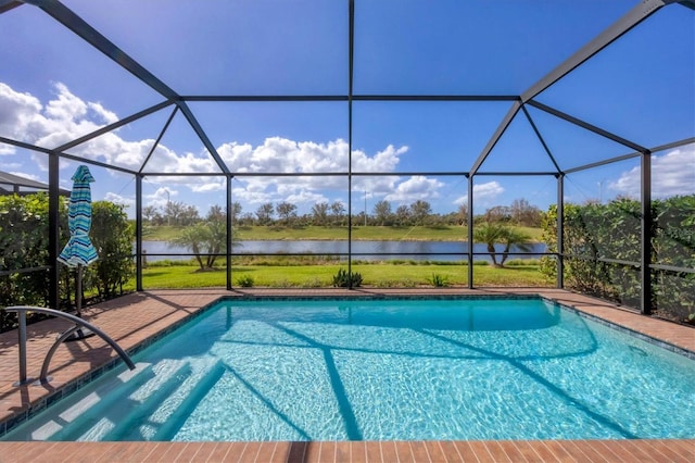 view of swimming pool featuring glass enclosure and a water view