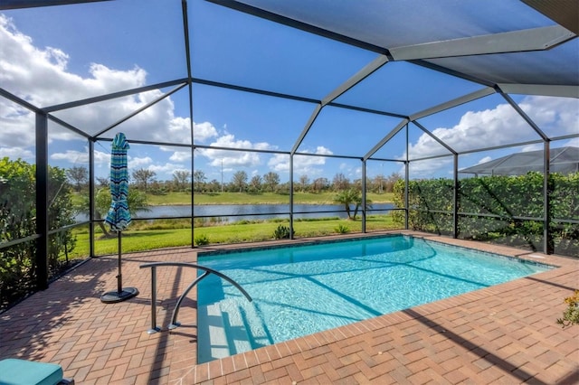 view of pool featuring a water view, a patio area, and glass enclosure