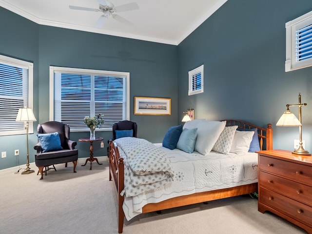 bedroom with baseboards, ornamental molding, a ceiling fan, and light colored carpet