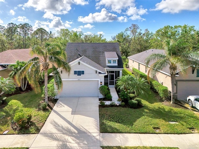 view of front of property with a front yard and a garage