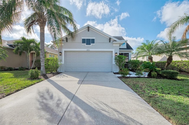 view of front of property featuring a garage and a front lawn