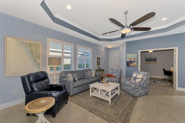 tiled living room featuring a raised ceiling, crown molding, and ceiling fan