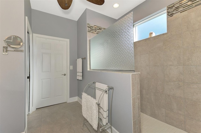 bathroom with tile patterned flooring, ceiling fan, and a tile shower