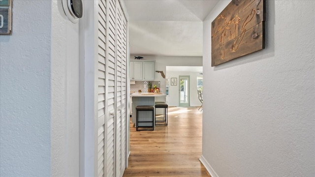 corridor with light hardwood / wood-style floors