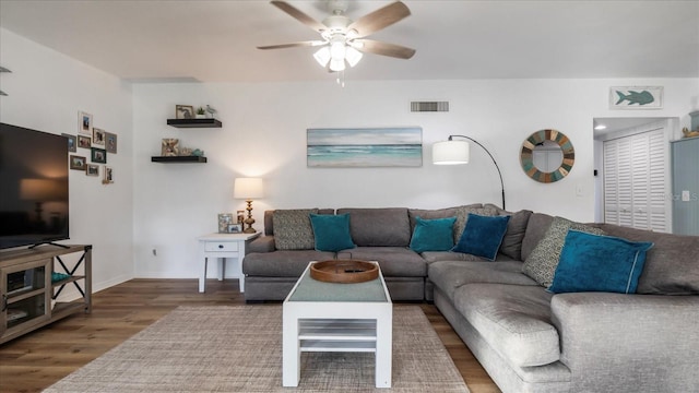 living room with ceiling fan and wood-type flooring