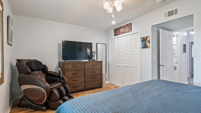 bedroom with a closet, ceiling fan, and light hardwood / wood-style flooring