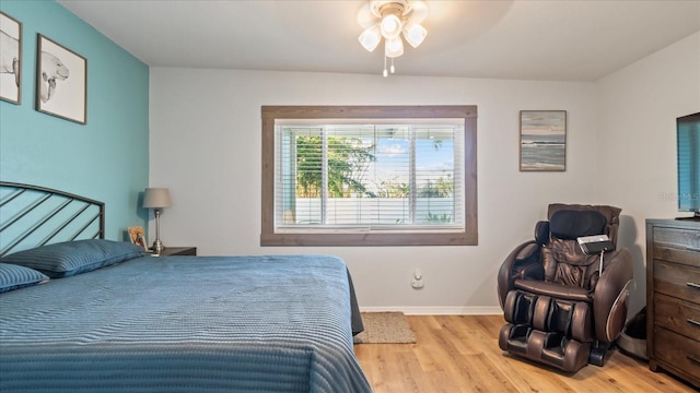 bedroom with ceiling fan and light wood-type flooring