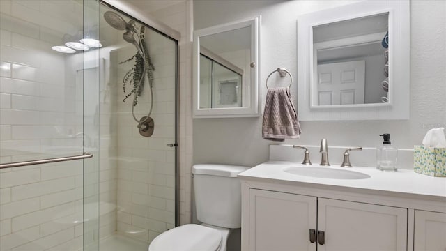 bathroom featuring vanity, toilet, and walk in shower