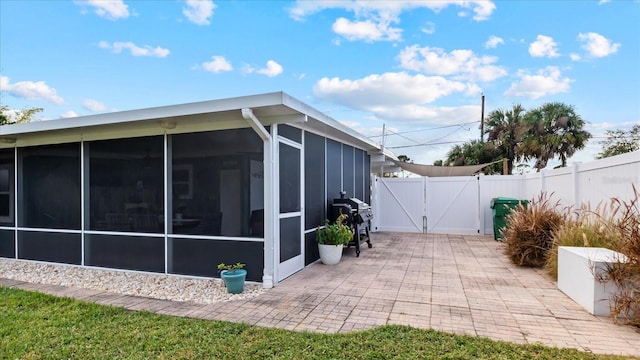 view of home's exterior featuring a patio and a sunroom