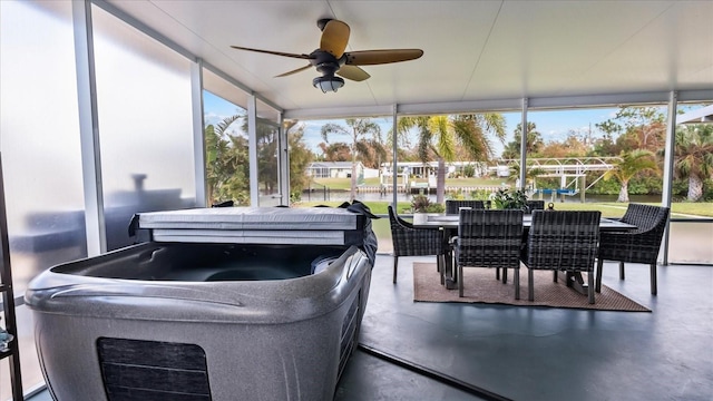 sunroom with ceiling fan and a jacuzzi