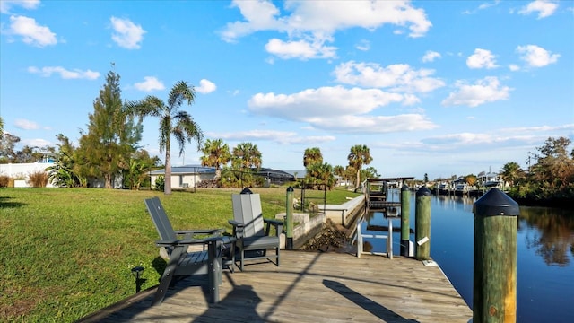 view of dock featuring a lawn and a water view