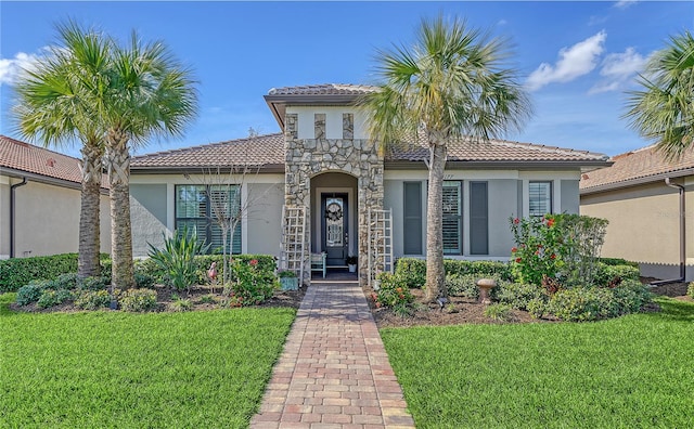 mediterranean / spanish-style house with a front yard