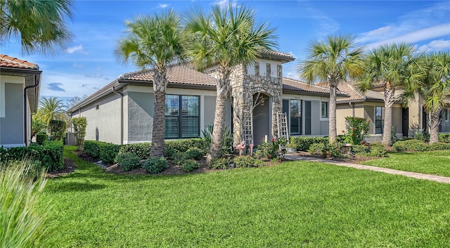 mediterranean / spanish-style house featuring a front lawn