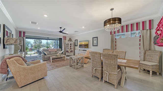 dining room featuring ceiling fan with notable chandelier, light wood-type flooring, and ornamental molding