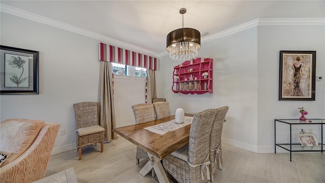 dining area featuring crown molding, light wood-type flooring, and a notable chandelier