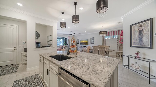 kitchen with dishwasher, sink, light stone counters, a center island with sink, and ceiling fan with notable chandelier