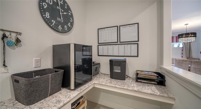 interior space with black fridge and a chandelier