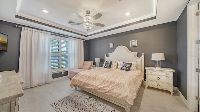 bedroom featuring a raised ceiling, ceiling fan, crown molding, and light wood-type flooring