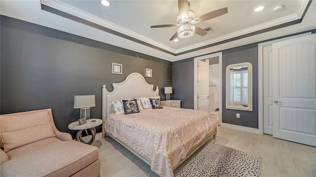 bedroom with a raised ceiling, ceiling fan, crown molding, and light wood-type flooring