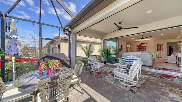 sunroom featuring ceiling fan