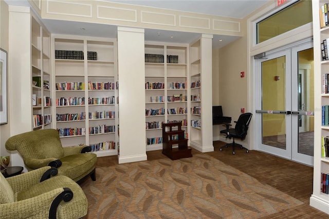 sitting room featuring dark hardwood / wood-style flooring and built in desk