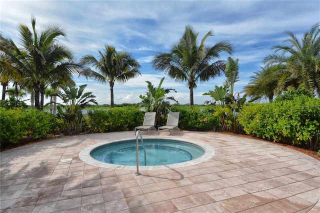 view of swimming pool with an in ground hot tub