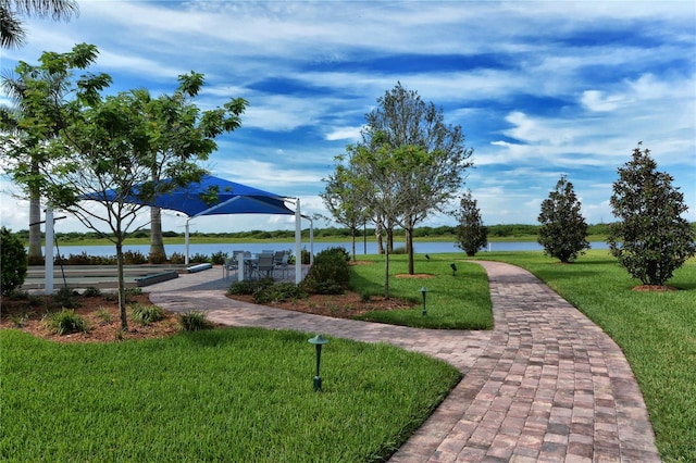 view of property's community featuring a water view and a yard