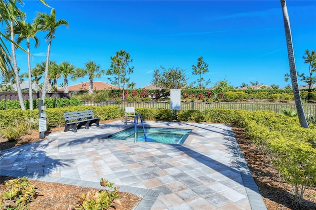 view of pool with a patio area and an in ground hot tub