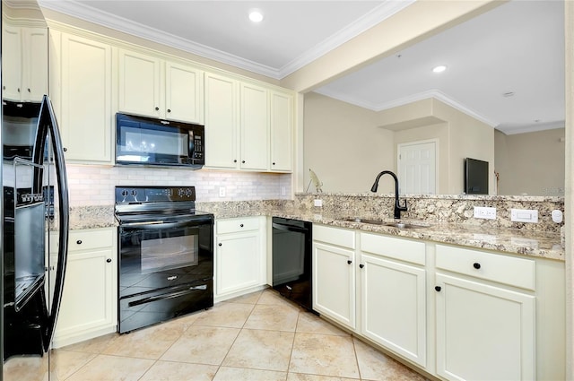 kitchen featuring sink, light stone counters, crown molding, cream cabinets, and black appliances