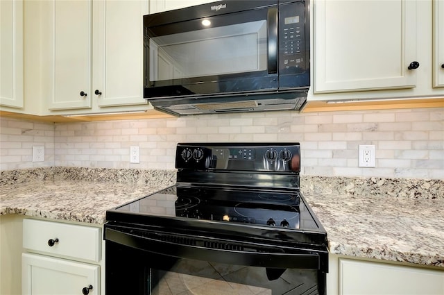 kitchen with black appliances, light stone counters, and backsplash