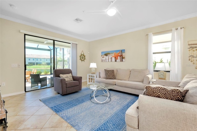 tiled living room featuring ceiling fan and ornamental molding