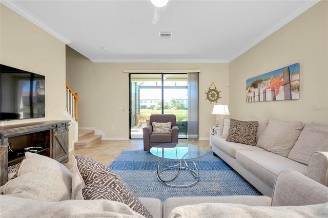 living room with ornamental molding and light tile patterned floors