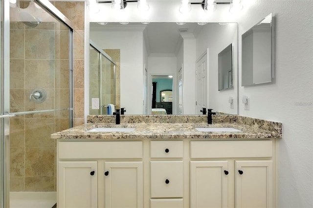 bathroom featuring vanity, crown molding, and walk in shower