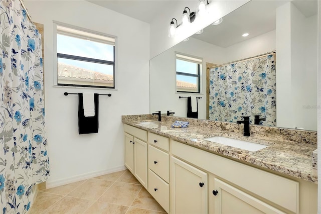 bathroom with tile patterned floors, vanity, and walk in shower