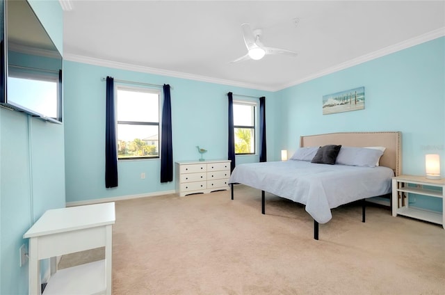 carpeted bedroom featuring ceiling fan and ornamental molding