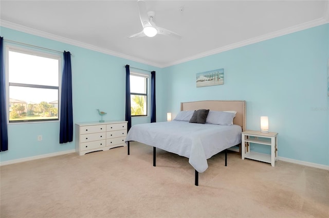 carpeted bedroom with ceiling fan and crown molding