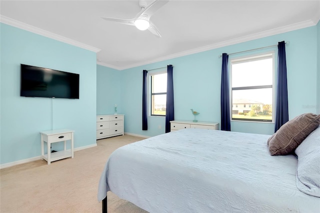 carpeted bedroom with ceiling fan and ornamental molding