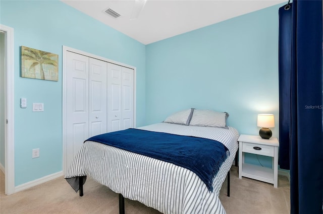 carpeted bedroom featuring a closet and ceiling fan