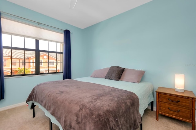 bedroom featuring light carpet