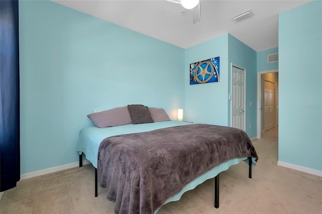 carpeted bedroom with ceiling fan and a closet