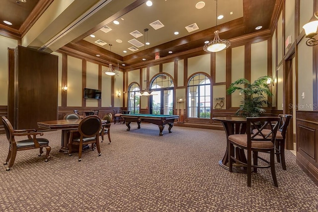 game room featuring pool table, carpet floors, a towering ceiling, a tray ceiling, and ornamental molding