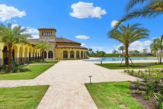 exterior space with a lawn and a pool