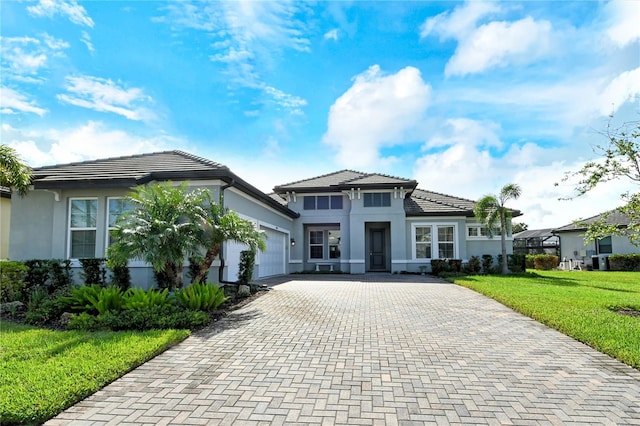 view of front of home featuring a garage and a front lawn