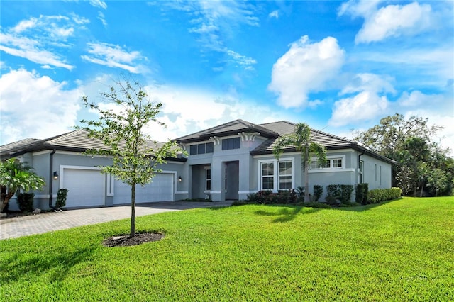 view of front of home with a front lawn and a garage