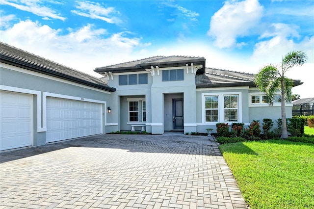 view of front of house with a front lawn and a garage