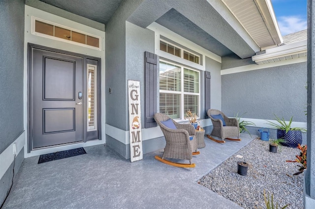 doorway to property featuring covered porch