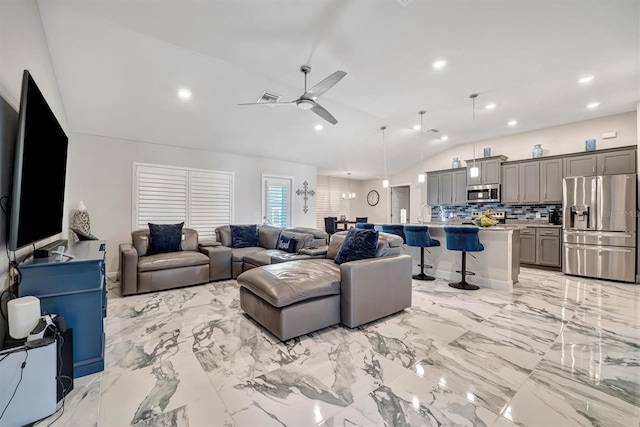 living room featuring ceiling fan and lofted ceiling