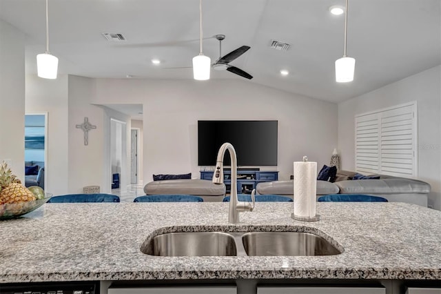 kitchen featuring sink, pendant lighting, vaulted ceiling, and ceiling fan