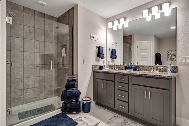 bathroom with walk in shower and vanity