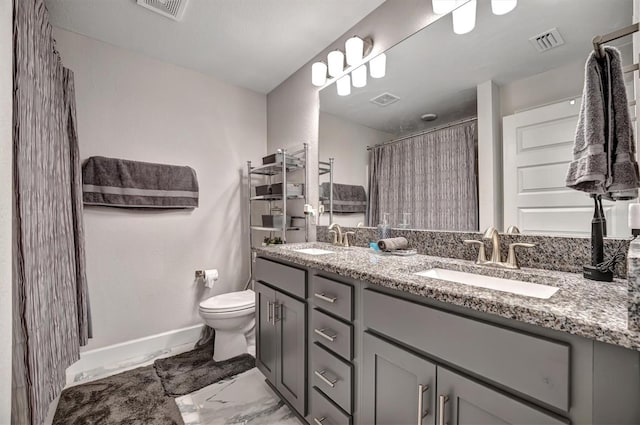 bathroom featuring curtained shower, vanity, and toilet